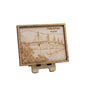Wooden plaque with laser-cut design of a bridge and engraved text on a beige background